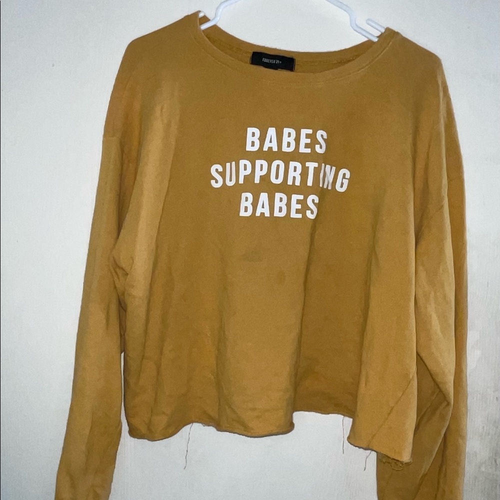 Yellow leeve crop top titled “babes support babes”